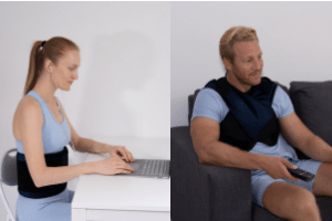 Woman wearing fat freezing belt with laptop and man wearing fat burner vest on sofa